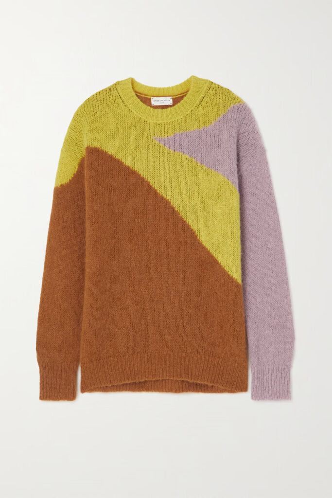 A Tish Intarsia oversize alpaca blend jumper in rust, featuring a vibrant geometric pattern in shades of mustard yellow, deep brown, and soft lilac. The bold design is captured against a clean white background, highlighting the jumper's cozy texture and relaxed fit that promises both comfort and style.